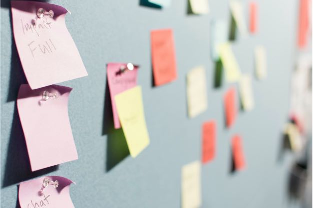 Post it notes pinned on a board during a workshop